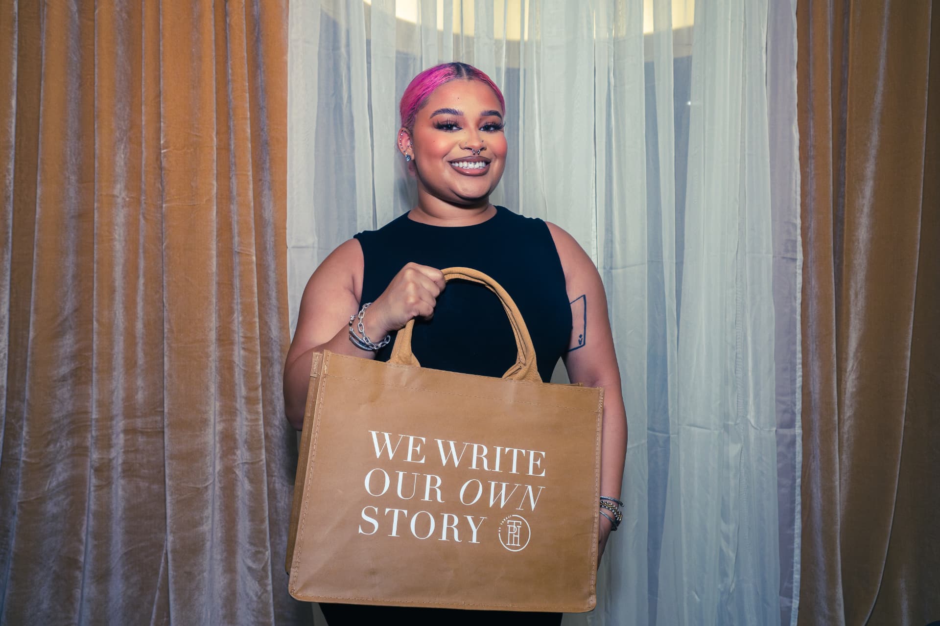 Guest holding a branded tote bag at an evening event
