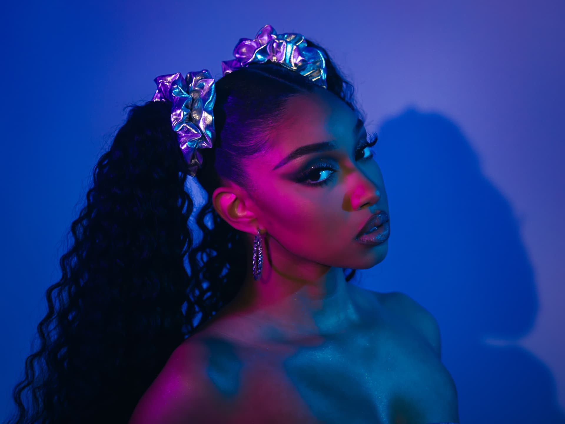 Creative beauty portrait in blue and magenta studio light