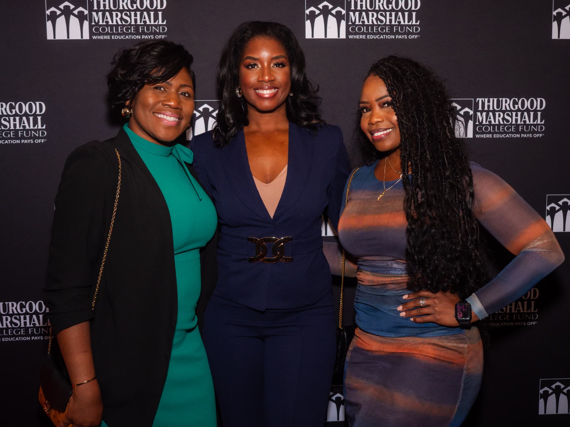 Three women posing together on the Thurgood Marshall College Fund step-and-repeat