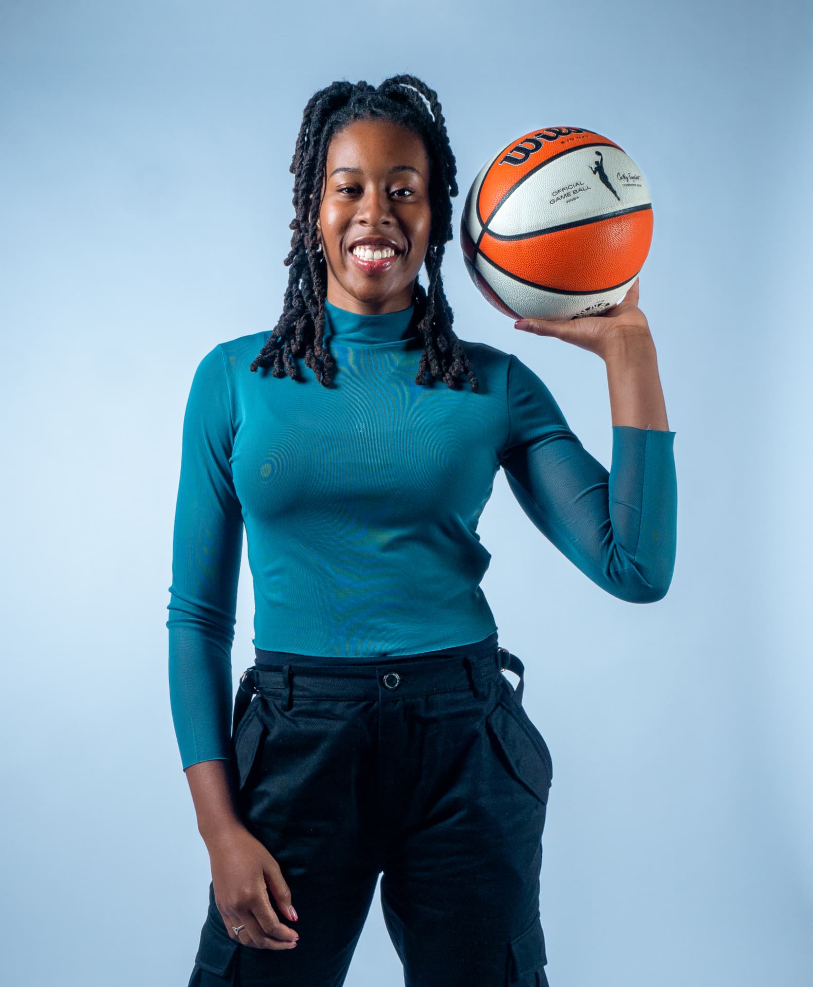 Studio portrait of an athlete balancing a basketball on her hand